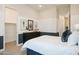 Bright bedroom featuring plush bedding, modern decor, and convenient closet and ensuite access at 15695 W Christy Dr, Surprise, AZ 85379