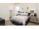 Cozy bedroom features a comfortable bed, side tables, and ample natural light from the window at 15695 W Christy Dr, Surprise, AZ 85379