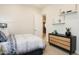 Modern bedroom featuring stylish decor, including floating shelves, a comfortable bed, and a contemporary dresser at 15695 W Christy Dr, Surprise, AZ 85379