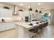 Stylish kitchen with white cabinets, stainless steel appliances, and an island with bar stools for casual dining and modern accents at 15695 W Christy Dr, Surprise, AZ 85379