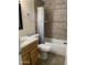 Bathroom featuring a tiled shower/tub, wooden vanity, and neutral walls, all well-maintained at 1750 E Mateo Cir # 106, Mesa, AZ 85204