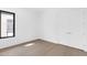 Empty bedroom with laminate wood floor, a window, and a double door closet at 19355 N 73Rd Way # 4002, Scottsdale, AZ 85255