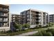 Stunning exterior view of modern apartment buildings boasting multiple balconies, surrounded by lush greenery at 19355 N 73Rd Way # 4002, Scottsdale, AZ 85255