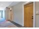 Hallway featuring wood-finished doors, modern lighting, and stylish carpet at 19355 N 73Rd Way # 4002, Scottsdale, AZ 85255