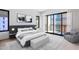 Serene bedroom with a plush bed, bench, large window with balcony access, and stylish decor at 19355 N 73Rd Way # 4002, Scottsdale, AZ 85255