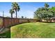 Spacious backyard with lush lawn, mature trees, and block wall at 1941 E Hazelwood St, Phoenix, AZ 85016