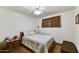 Bedroom with a queen bed, ceiling fan, and dark brown carpet at 1941 E Hazelwood St, Phoenix, AZ 85016