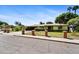 Traditional home showcasing a brick-accented fence and landscaped front yard under a clear blue sky at 1941 E Hazelwood St, Phoenix, AZ 85016