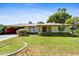 Charming home featuring a well-manicured front lawn and welcoming curb appeal on a sunny day at 1941 E Hazelwood St, Phoenix, AZ 85016