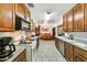 Spacious kitchen with oak cabinets, tile flooring, and views through to the adjacent dining area at 1941 E Hazelwood St, Phoenix, AZ 85016