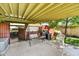 Comfortable covered patio with swing, chairs, and adjacent carport at 1941 E Hazelwood St, Phoenix, AZ 85016