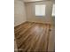 Bright bedroom featuring a window, neutral walls, and new wood-style floors at 2121 W Royal Palm Rd # 2049, Phoenix, AZ 85021