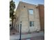 The exterior of this 2-story building features stucco walls, a streetlight and simple landscaping at 2121 W Royal Palm Rd # 2049, Phoenix, AZ 85021