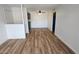 Spacious living room with modern lighting and neutral walls, leading into kitchen at 2121 W Royal Palm Rd # 2049, Phoenix, AZ 85021