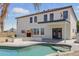 Spacious backyard featuring a pool and outdoor stone fireplace, perfect for entertaining at 23214 N 106Th Ave, Peoria, AZ 85383