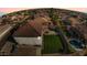 Aerial view of a backyard featuring a pool, grass area, and privacy fence at 23214 N 106Th Ave, Peoria, AZ 85383