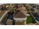 Aerial view of a backyard featuring a swimming pool and grassy backyard with a privacy fence at 23214 N 106Th Ave, Peoria, AZ 85383