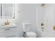 Bright bathroom featuring elegant gold fixtures, a modern vanity, and a shower-tub combination with a shower head at 23214 N 106Th Ave, Peoria, AZ 85383