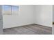 A simply designed bedroom with gray carpet, white walls, a window for natural light, and baseboard trim at 23214 N 106Th Ave, Peoria, AZ 85383