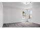 Neutral bedroom with carpet, white walls, a ceiling fan, and two windows letting in sunlight at 23214 N 106Th Ave, Peoria, AZ 85383