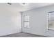 Clean bedroom with neutral carpet, white walls, a ceiling fan, and two partially-frosted windows at 23214 N 106Th Ave, Peoria, AZ 85383