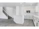 White kitchen with bright white cabinets, stainless steel microwave, quartz countertops, and light gray flooring at 23214 N 106Th Ave, Peoria, AZ 85383