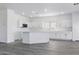 Bright kitchen featuring white cabinets, white quartz countertops, stainless steel appliances, and light gray flooring at 23214 N 106Th Ave, Peoria, AZ 85383