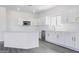 Bright kitchen featuring white cabinets with gold handles, quartz countertops, and stainless steel appliances at 23214 N 106Th Ave, Peoria, AZ 85383