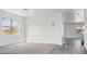 Bright living room featuring gray carpet, white walls with modern molding, and large windows for natural light at 23214 N 106Th Ave, Peoria, AZ 85383