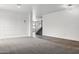 Bright living room with gray carpet, white walls, modern molding, and staircase leading to the upper level at 23214 N 106Th Ave, Peoria, AZ 85383