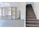 Living room view with stone shelves, light gray floors, and a carpeted staircase leading to the upper level at 23214 N 106Th Ave, Peoria, AZ 85383