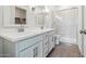 Bright bathroom features double sinks, modern fixtures, a glass-enclosed shower, and tiled floors at 23419 W Albeniz Pl, Buckeye, AZ 85326