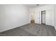 Empty bedroom, featuring carpet flooring, a closet and a window at 23419 W Albeniz Pl, Buckeye, AZ 85326