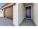 Close-up of the home's entryway showing a blue front door and stucco walls at 23419 W Albeniz Pl, Buckeye, AZ 85326