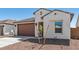 Home featuring a two-car garage, desert landscaping, and light-colored exterior paint at 23419 W Albeniz Pl, Buckeye, AZ 85326