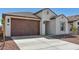 Charming single-story home showcasing a two-car garage and landscaped front yard at 23419 W Albeniz Pl, Buckeye, AZ 85326