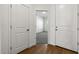 Hallway view to the bedroom with carpet flooring and white walls and doors at 23419 W Albeniz Pl, Buckeye, AZ 85326