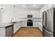 Modern kitchen with stainless steel appliances, granite countertops and tile backsplash at 23419 W Albeniz Pl, Buckeye, AZ 85326