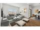 Cozy living room with a large sectional sofa, modern art, and plenty of natural light at 23419 W Albeniz Pl, Buckeye, AZ 85326