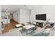 Bright living room with hardwood floors, white walls, and modern furnishings at 23419 W Albeniz Pl, Buckeye, AZ 85326