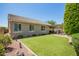 Backyard with green lawn, patio, and desert landscaping at 2440 W Arroyo Way, San Tan Valley, AZ 85144