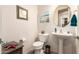 Half bathroom with pedestal sink, toilet, and decorative accents at 2440 W Arroyo Way, San Tan Valley, AZ 85144