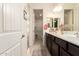 Bright bathroom with dual vanity, neutral tile floors, and shower-tub combo in separate room at 2440 W Arroyo Way, San Tan Valley, AZ 85144
