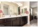 The bathroom has dual sinks, a mirror, and a view into the main bedroom at 2440 W Arroyo Way, San Tan Valley, AZ 85144