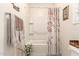 Bathroom featuring white shower-tub combo with decorative floral shower curtain and framed wall art at 2440 W Arroyo Way, San Tan Valley, AZ 85144