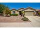 Charming single-story home featuring a well-manicured front yard with desert landscaping and a two-car garage at 2440 W Arroyo Way, San Tan Valley, AZ 85144