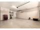Open garage with epoxy flooring, built in cabinets for organized storage, and overhead lighting at 2440 W Arroyo Way, San Tan Valley, AZ 85144