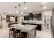 Spacious kitchen with dark cabinets, stainless steel appliances, a granite island, and an open layout at 2440 W Arroyo Way, San Tan Valley, AZ 85144