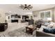 Open-concept living space featuring a large rug, comfortable sofas, and a view into the modern kitchen at 2440 W Arroyo Way, San Tan Valley, AZ 85144