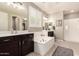 Gorgeous primary bathroom with dual sinks, soaking tub and walk-in shower at 2440 W Arroyo Way, San Tan Valley, AZ 85144